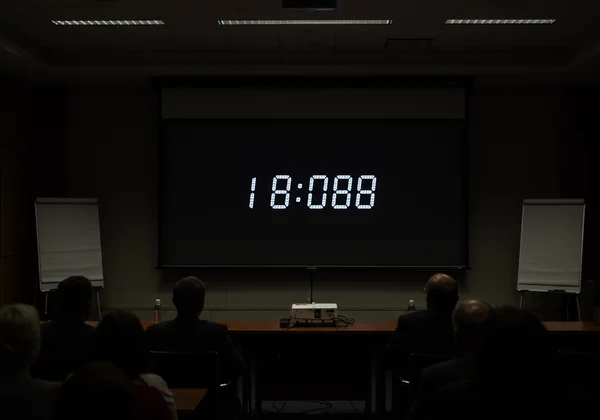 Large TimeScreen clock on a projector in a presentation room
